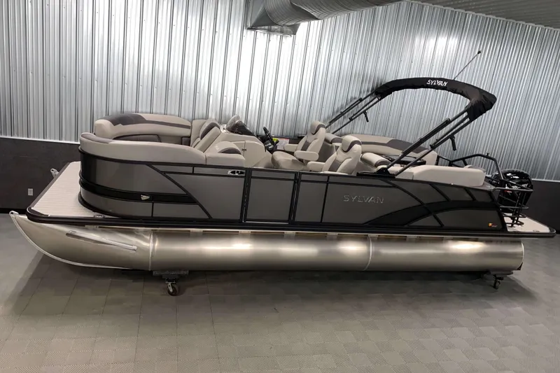 The Image of 2025 Sylvan L3 LZ pontoon boat in a modern indoor showroom. - 0