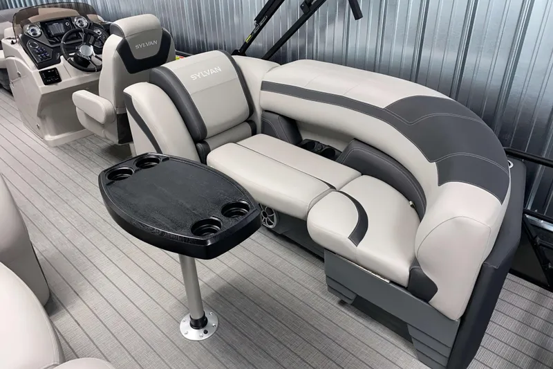 Slide: The Image of Luxurious interior of 2025 Sylvan L3 LZ pontoon boat with plush seating and table. - 10