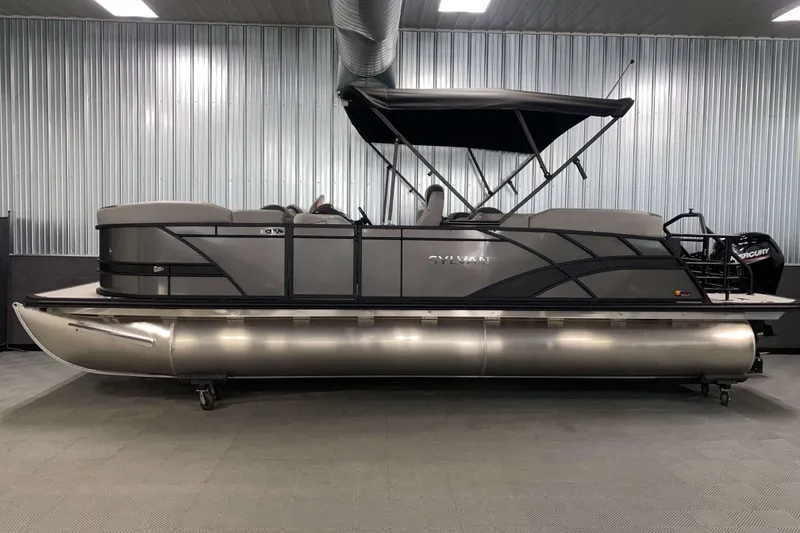 Slide: The Image of 2025 Sylvan L3 LZ pontoon boat in a showroom, featuring sleek design and modern amenities. - 16