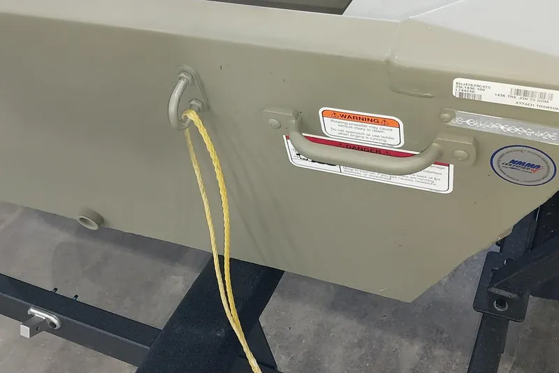 Slide: The Image of 2025 Tracker Grizzly 1436 Utility boat transom with warning labels and rope attachment. - 15