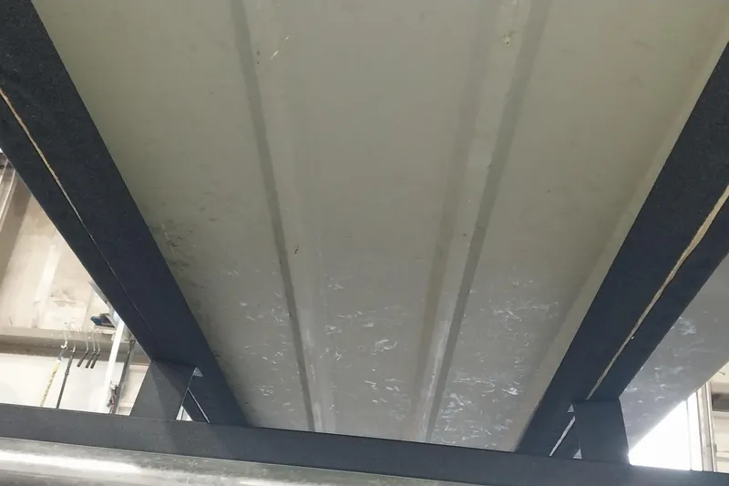 Slide: The Image of Underside view of 2025 Tracker Grizzly 1436 Utility boat in a workshop. - 17