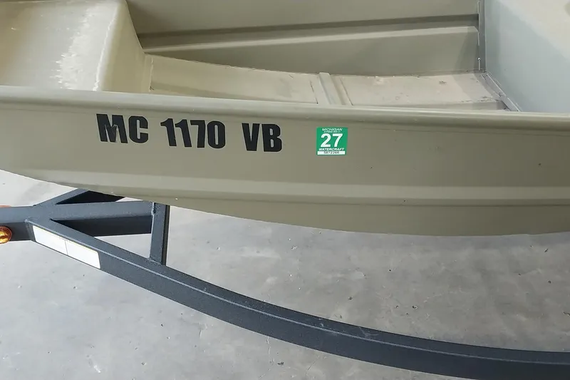Slide: The Image of 2025 Tracker Grizzly 1436 Utility boat on trailer with registration sticker. - 6