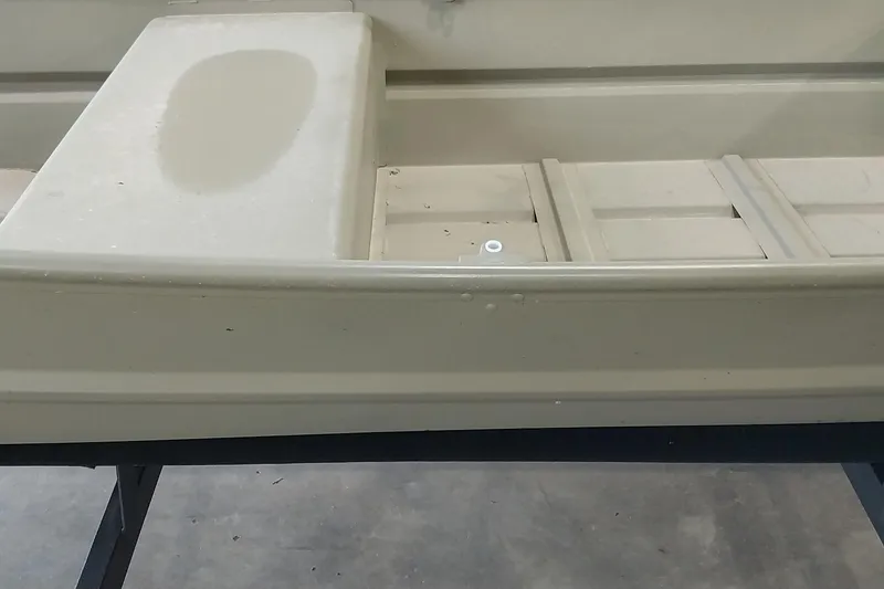 Slide: The Image of 2025 Tracker Grizzly 1436 Utility boat interior, showcasing seating and storage compartments. - 7