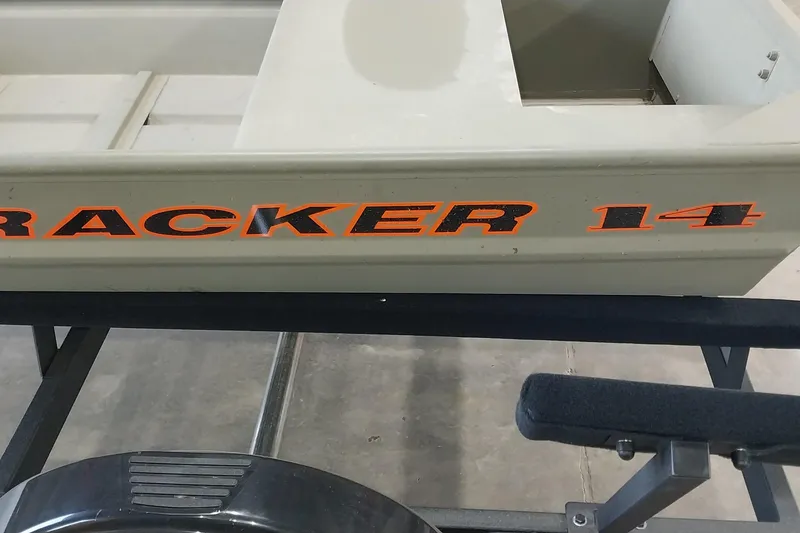 Slide: The Image of 2025 Tracker Grizzly 1436 Utility boat with bold orange lettering on the side. - 8