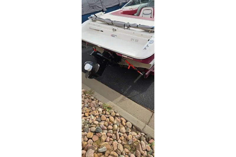 Slide: The Image of 1992 Starcraft Elite 171 boat rear view with outboard motor and red interior. - 4