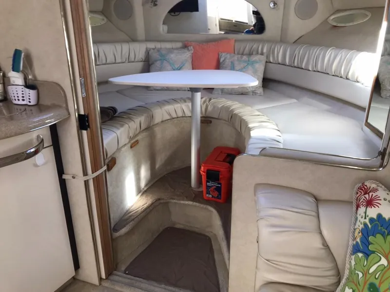 Slide: The Image of Interior of 1997 Sea Ray 330 Express Cruiser with cozy seating and table. - 14