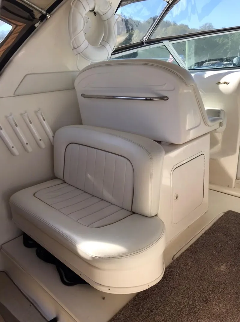 Slide: The Image of 1997 Sea Ray 330 Express Cruiser interior with white seating and elegant design. - 23