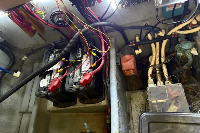 Slide: The Image of Engine compartment of a 1997 Sea Ray 330 Express Cruiser with batteries and wiring. - 27