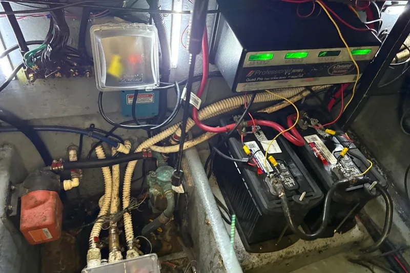 Slide: The Image of Engine compartment of a 1997 Sea Ray 330 Express Cruiser with batteries and wiring. - 28