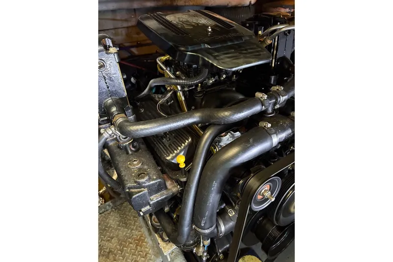 Slide: The Image of Engine of a 1997 Sea Ray 330 Express Cruiser with visible hoses and components. - 32