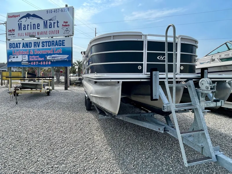 The Image of 2016 Harris Cruiser 240 pontoon boat on trailer, labeled "No Bad Days," under a clear blue sky. - 0