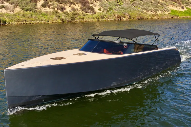 Slide: The Image of 2015 VanDutch 40 yacht cruising on a scenic waterway. - 15