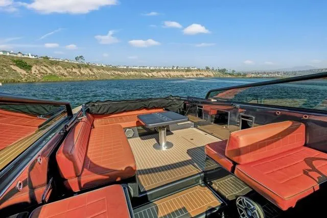 Slide: The Image of Luxurious 2015 VanDutch 40 yacht interior with red seating, table, and scenic water view. - 20