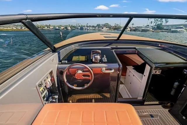 Slide: The Image of 2015 VanDutch 40 yacht cockpit with leather seating and modern controls on open water. - 24