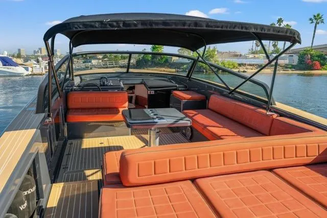 Slide: The Image of 2015 VanDutch 40 yacht with orange seating, black canopy, and sleek design on the water. - 46