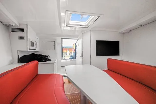 Slide: The Image of Interior of 2015 VanDutch 40 yacht with red seating and modern amenities. - 51
