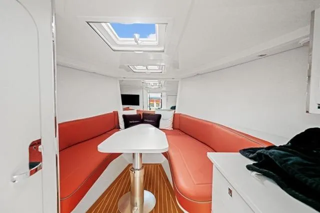 Slide: The Image of Interior of 2015 VanDutch 40 yacht with red seating and modern design. - 53