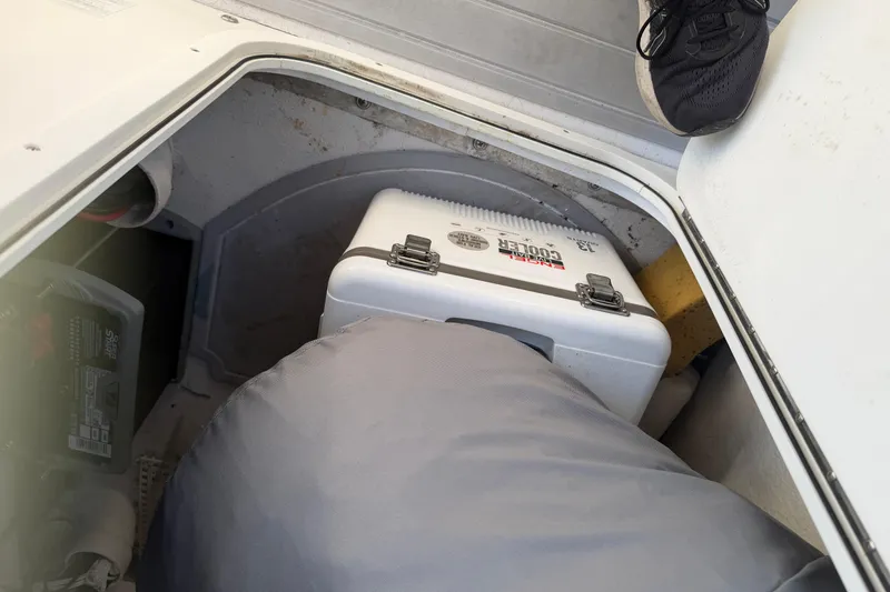 Slide: The Image of Storage compartment of a 2018 Twin Vee 260 CC SE boat with cooler and batteries. - 10