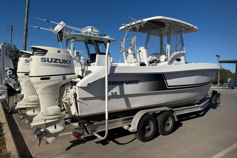 Slide: The Image of 2018 Twin Vee 260 CC SE boat with Suzuki engines on a trailer. - 2
