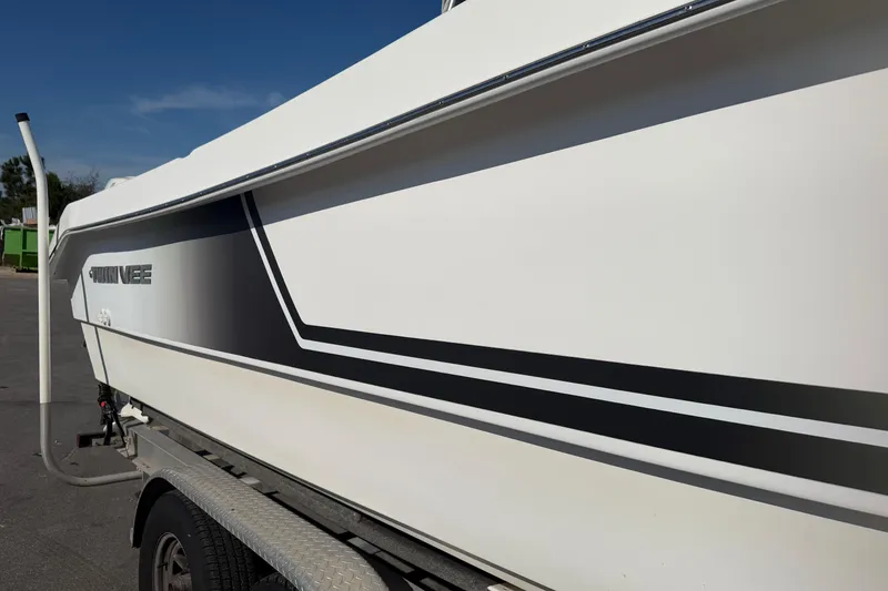 Slide: The Image of 2018 Twin Vee 260 CC SE boat on trailer, side view with sleek design. - 20