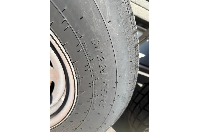 Slide: The Image of Close-up of a trailer tire with "ST225/75R15" marking, suitable for Twin Vee 260 CC SE 2018. - 23