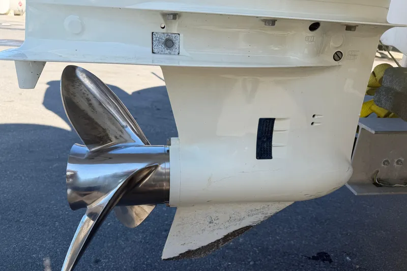 Slide: The Image of Close-up of a 2018 Twin Vee 260 CC SE boat propeller and lower unit. - 31