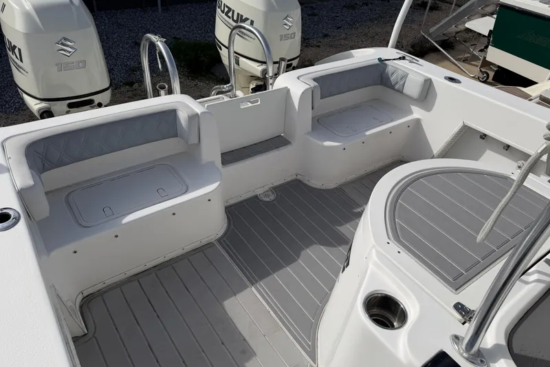 Slide: The Image of 2018 Twin Vee 260 CC SE boat interior with seating and Suzuki engines. - 34