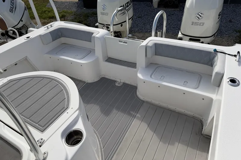 Slide: The Image of 2018 Twin Vee 260 CC SE boat interior with seating and Suzuki 150 engines. - 35