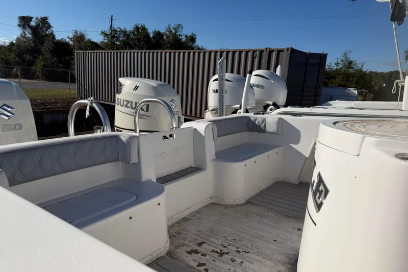 Slide: The Image of 2018 Twin Vee 260 CC SE boat interior with seating and railing under clear blue sky. - 4