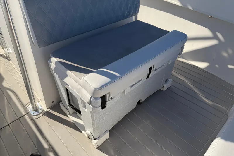 Slide: The Image of 2018 Twin Vee 260 CC SE boat with T-top and clear enclosure, parked outdoors. - 6
