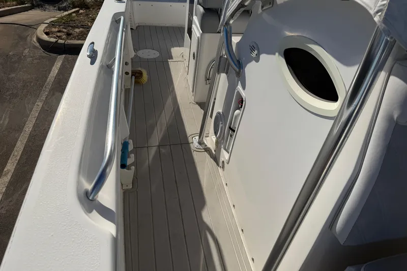 Slide: The Image of 2018 Twin Vee 260 CC SE boat deck with storage compartment and railing. - 8