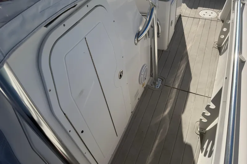 Slide: The Image of Storage compartment in a 2018 Twin Vee 260 CC SE boat with cooler and equipment. - 9