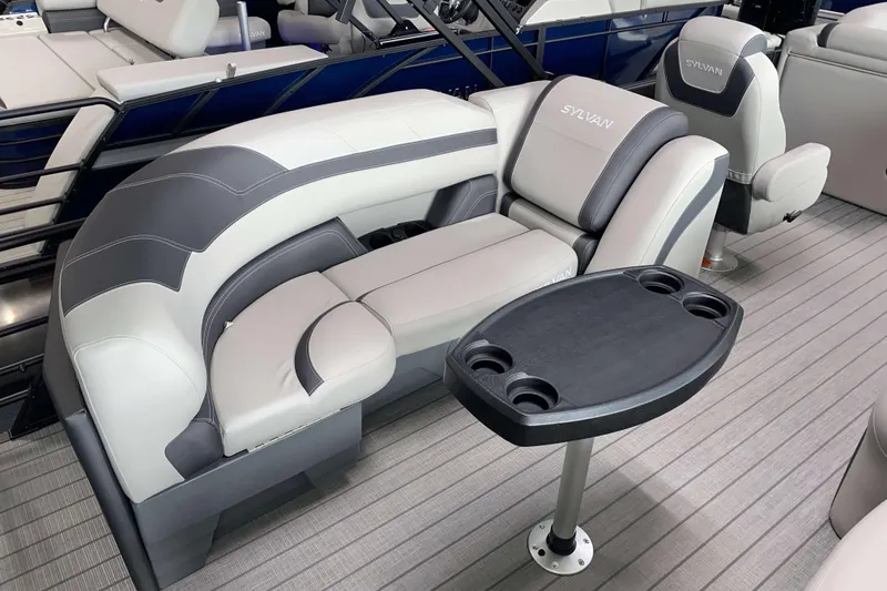 Slide: The Image of 2025 Sylvan L3 LZ boat interior with plush seating and a convenient cupholder table. - 10