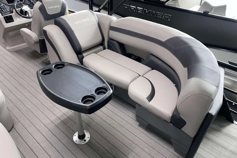 Slide: The Image of 2025 Sylvan L3 LZ boat interior with plush seating and a cupholder table. - 11