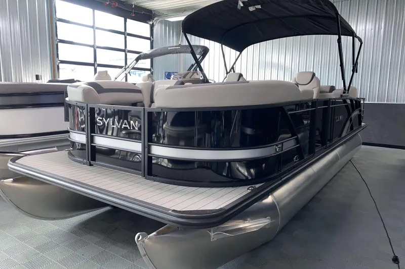 Slide: The Image of 2025 Sylvan L3 LZ pontoon boat in showroom, featuring sleek design and comfortable seating. - 13