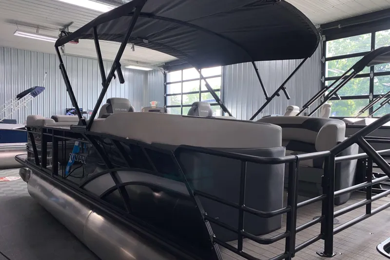 Slide: The Image of 2025 Sylvan L3 LZ pontoon boat in showroom, featuring sleek design and comfortable seating. - 15