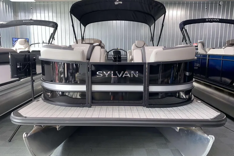 Slide: The Image of 2025 Sylvan L3 LZ pontoon boat in showroom, featuring sleek design and comfortable seating. - 16