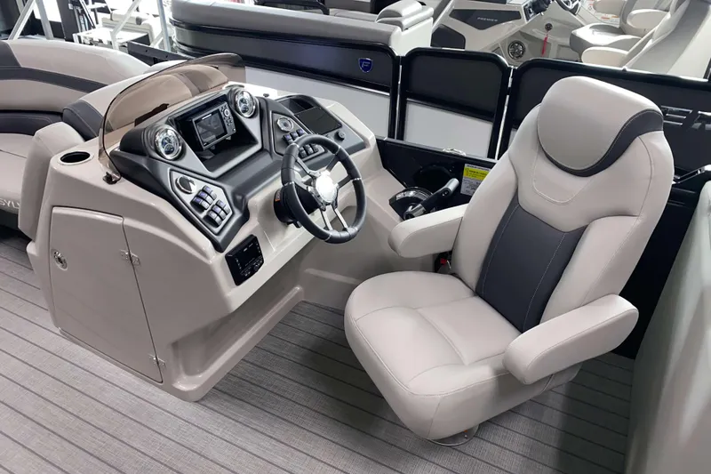 Slide: The Image of Captain's seat and helm of 2025 Sylvan L3 LZ pontoon boat, featuring modern controls. - 7