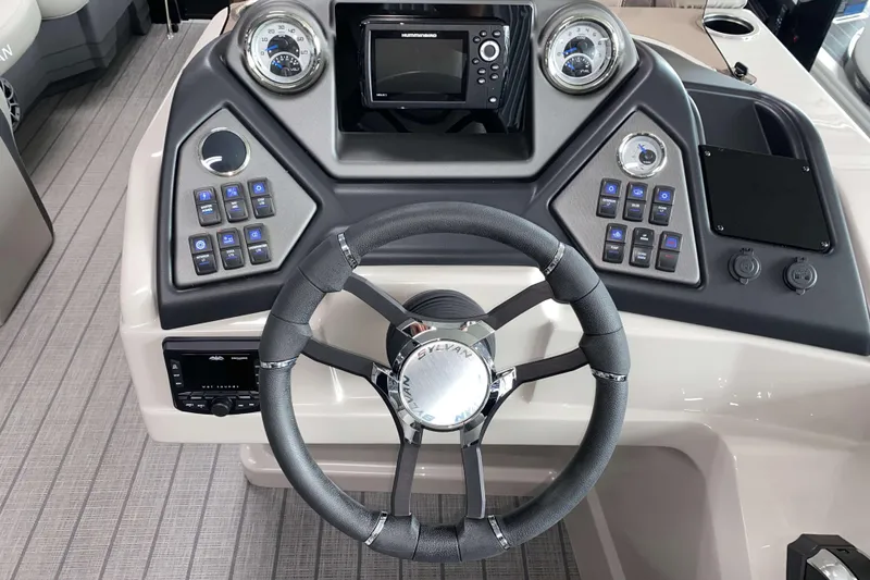 Slide: The Image of 2025 Sylvan L3 LZ boat dashboard with steering wheel and control panel. - 9