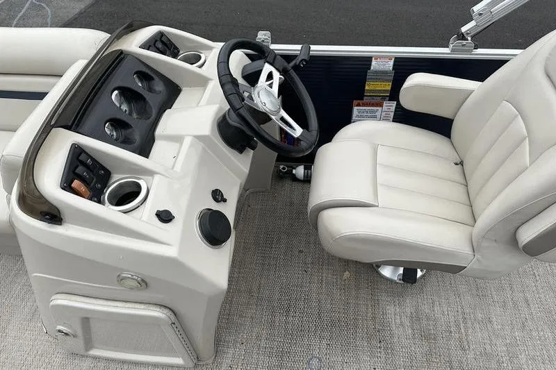 Slide: The Image of 2018 Bennington 21SLX boat interior with steering console and plush captain's chair. - 10