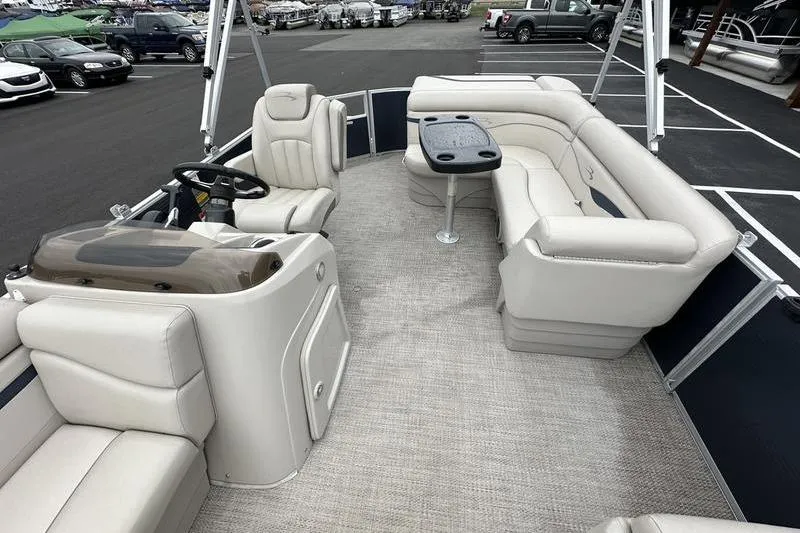 Slide: The Image of 2018 Bennington 21SLX pontoon boat interior with plush seating and steering console. - 11