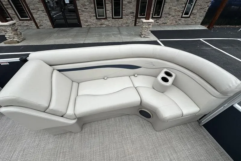 Slide: The Image of Luxurious seating on a 2018 Bennington 21SLX pontoon boat, featuring plush upholstery and cup holders. - 12