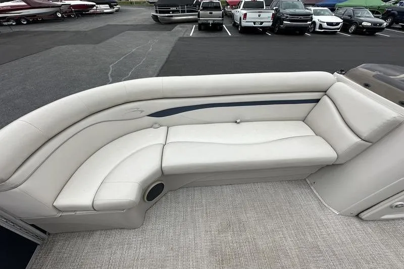 Slide: The Image of 2018 Bennington 21SLX boat interior with white cushioned seating and carpeted floor. - 13