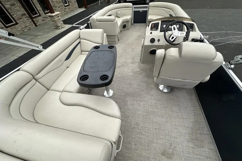 Slide: The Image of 2018 Bennington 21SLX pontoon boat interior with beige seating and steering console. - 20