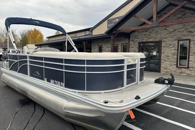 Slide: The Image of 2018 Bennington 21SLX pontoon boat parked outside a stone building. - 3
