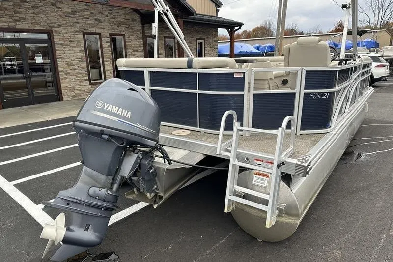 Slide: The Image of 2018 Bennington 21SLX pontoon boat with Yamaha outboard motor, parked outdoors. - 5