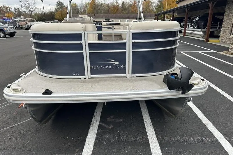 Slide: The Image of 2018 Bennington 21SLX pontoon boat parked in a lot, rear view. - 7