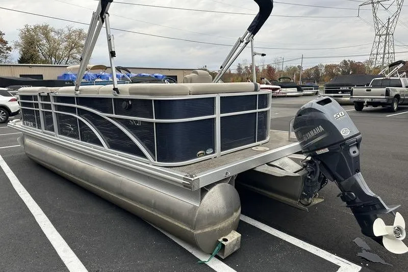 Slide: The Image of 2018 Bennington 21SLX pontoon boat with Yamaha outboard motor in parking lot. - 8