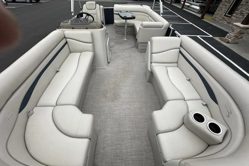 Slide: The Image of 2018 Bennington 21SLX pontoon boat interior with beige seating and cup holders. - 9