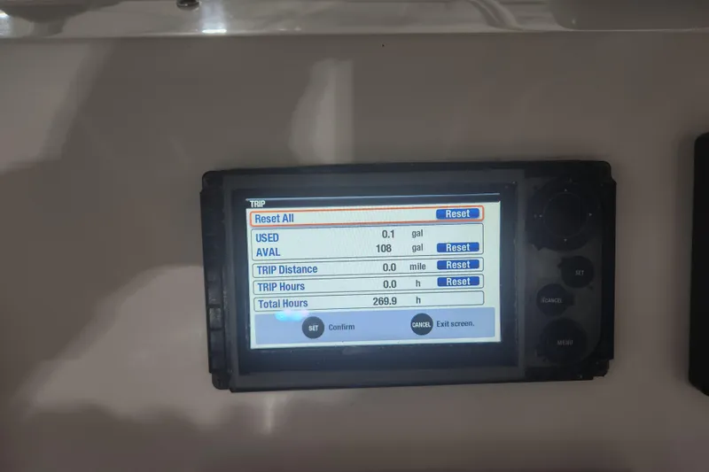 Slide: The Image of Control panel of a 2012 Edgewater 228CC boat with warning labels and cup holders. - 12